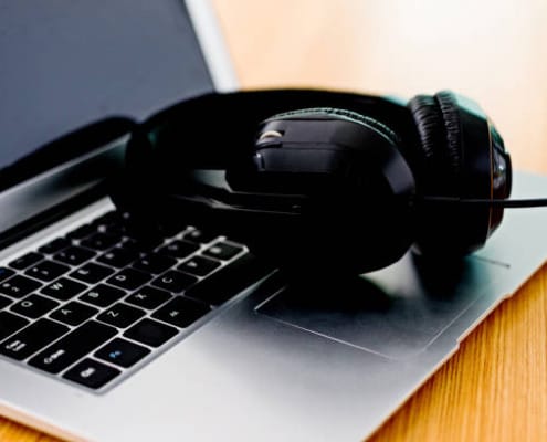black headphone on a laptop computer.