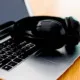 black headphone on a laptop computer.
